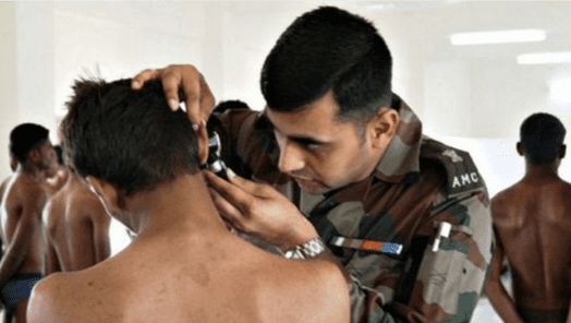 An ENT doctor examining ears of a candidate.