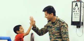 An army doctor with a child