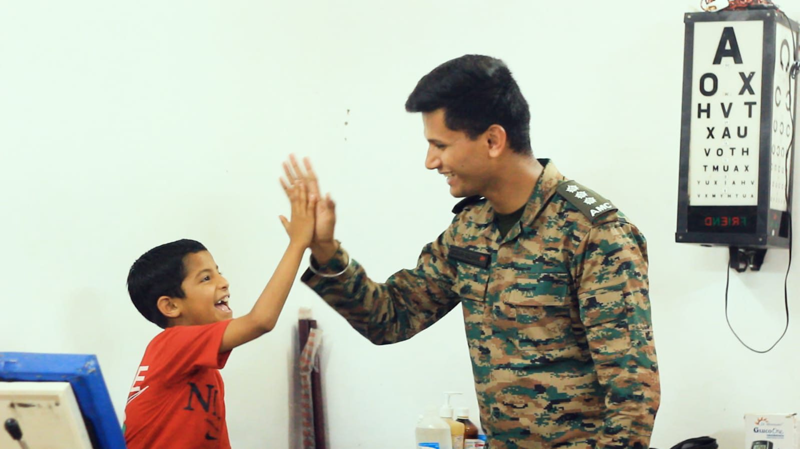 An army doctor with a child