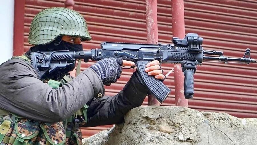 An army personnel carry a service rifle. 